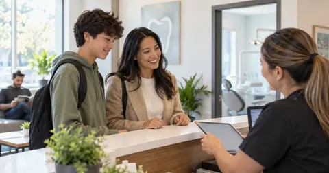 Parent and teen checking in at the dentist